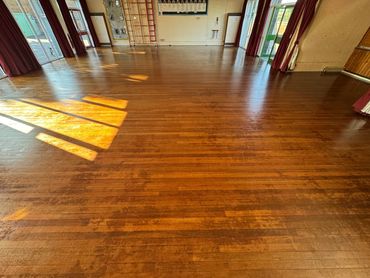 Worn Hardwood strip floor in a junior school in Leicestershire.