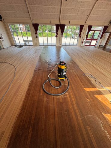 Partially sanded school hall floor 