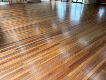 Freshly restored wood strip floor in a multi-use area