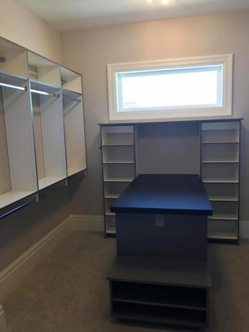 master closet with a peninsula and pul