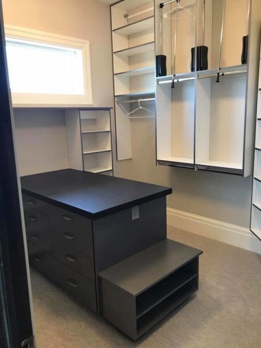 master closet with peninsula and bench