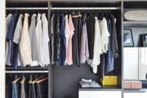 modern closet with row of cloths hangi