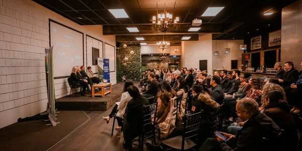 Panel discussion with an engaged audience in a modern conference room.