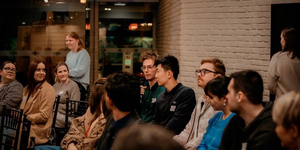 A group of people attentively listening during a discussion or presentation.
