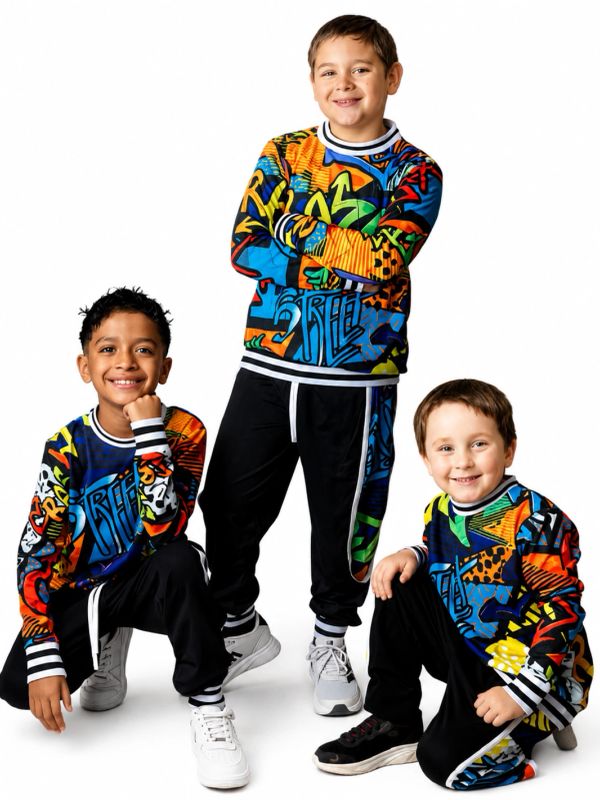 Three boys in colorful sweatshirts and black pants posing together.