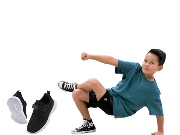 Boy posing with black sneakers and black Converse shoes.