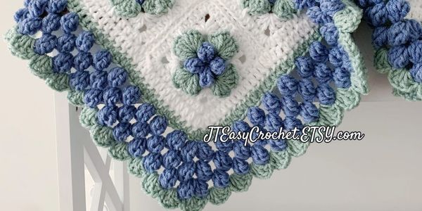 Beautiful crochet blueberry granny square baby blanket with blueberry border