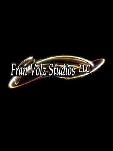 Fran Volz Studios LLC logo with glowing light effects on black background.