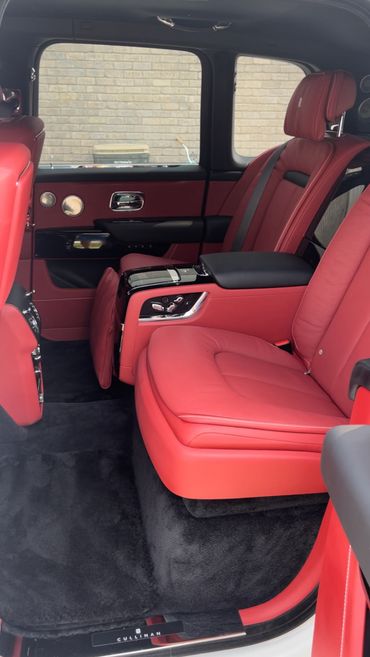 Luxurious red leather rear seats inside a Rolls-Royce Cullinan.