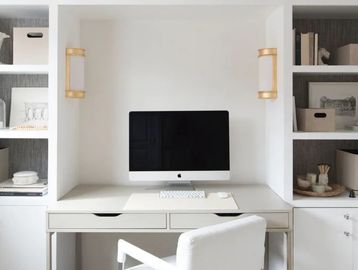 Amenities Page. Contemporary, white SoHo office desk, shelving, iMac computer, and seating.