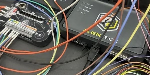 A complex setup of colorful wires connected to electronic devices on a table.