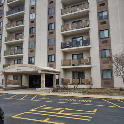 Apartment building with reserved parking spaces marked on asphalt.