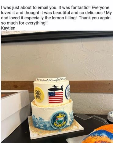 Two-tiered cake with military-themed decorations and a thank you note from Kaytlen.