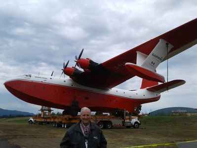 Patrick J. Phillips in front of the Martin Mars Water Bomber at the BC Aviation Museum.