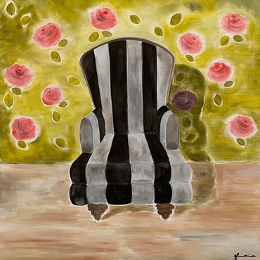 Black and white striped armchair in front of floral wallpaper.