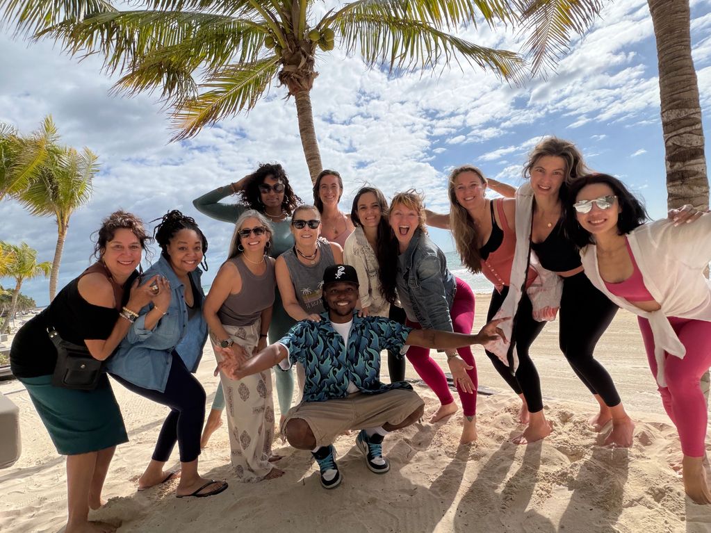 Group of friends posing happily on a tropical beach.