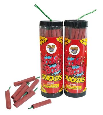 Two containers of Boom Boom Crackers firecrackers with some loose crackers beside them.