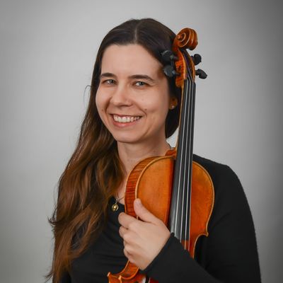 Woman smiling and holding a violin