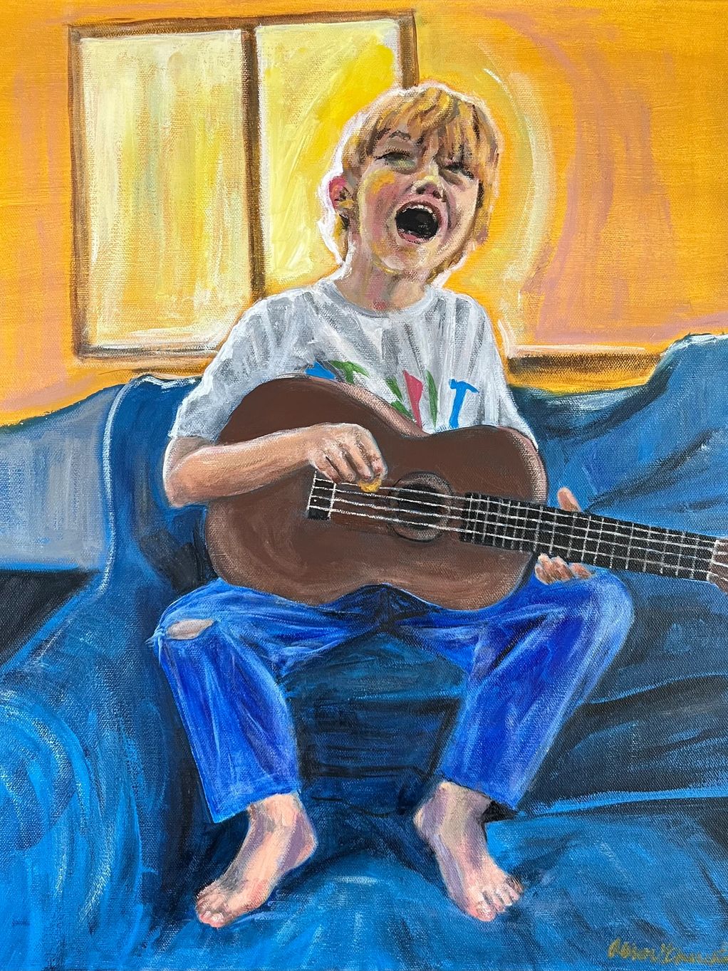 Boy playing a ukelele and singing.