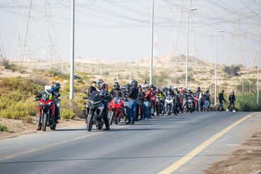 Waiting for therest. Ducati Motorcycles standing on the side of the road.