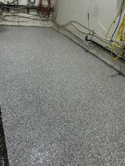 Newly installed speckled epoxy floor in a utility room.