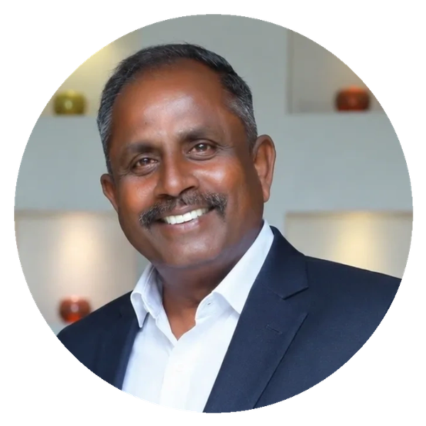 Smiling man in a navy blue suit jacket and white shirt.