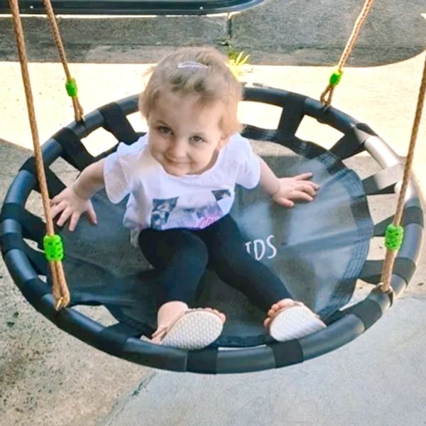Children engaging in play therapy on a swing