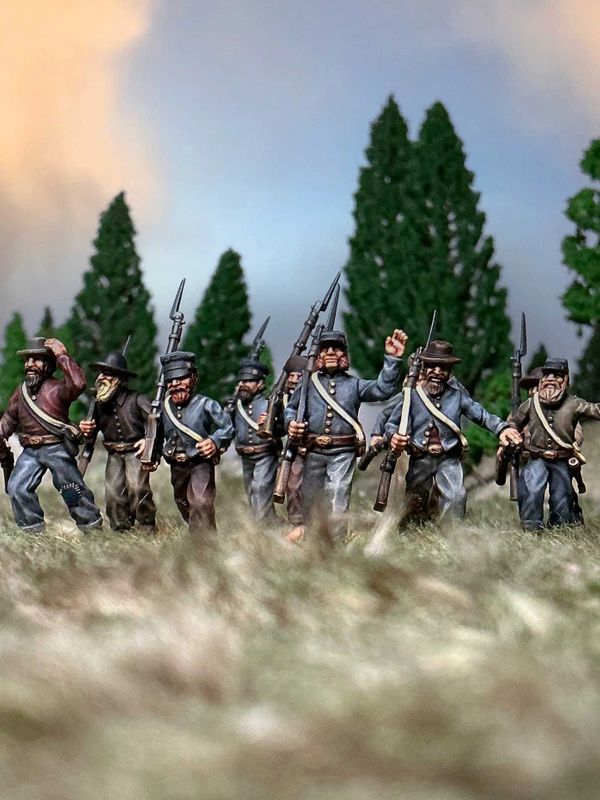 Miniature soldiers in Civil War uniforms advancing in a diorama.