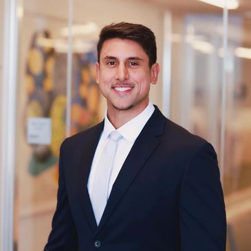 Professional man in suit smiling indoors.