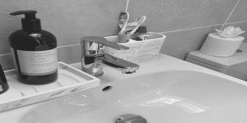 Modern bathroom sink with soap and decor.