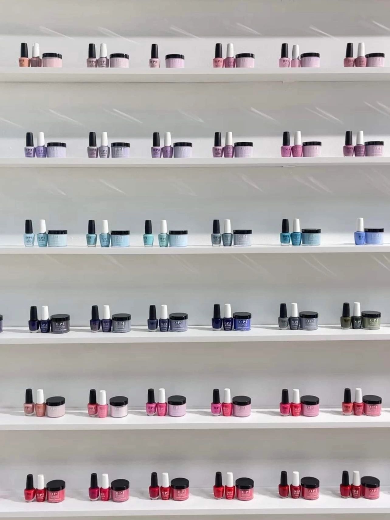 OPI polish, gel, and dip displayed on a wall