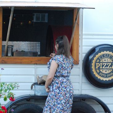 image of Norfolk event planning by Genepy Events. Woman standing in front of a pizza van