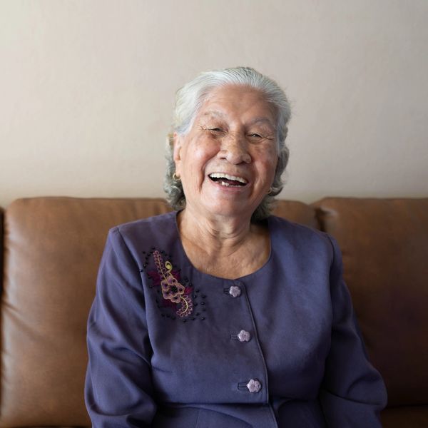 Joyful elderly woman with a purple jacket