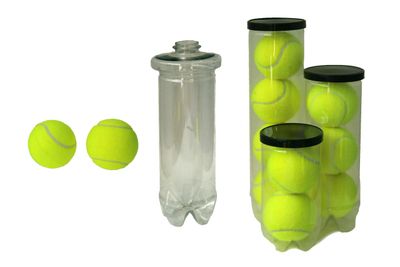 Tennis balls stored in plastic bottles, repurposing containers creatively.
