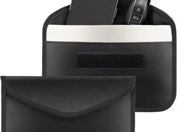 Black pouch holding a smartphone and a car key fob.