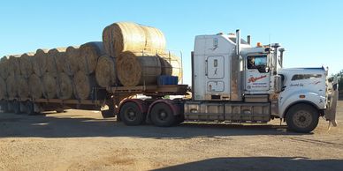 One of our Mid North Freight Service trucks transporting a large load of hay