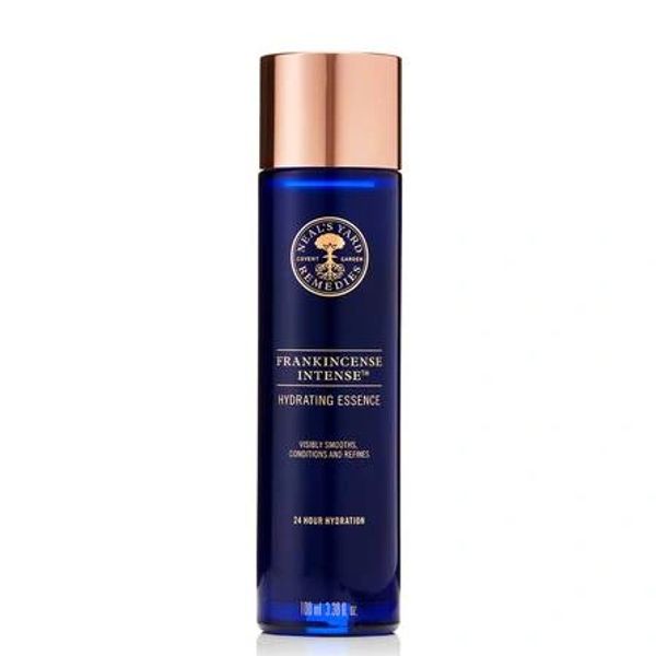 Luxurious dark blue glass bottle of skincare with rose gold lid and writing 