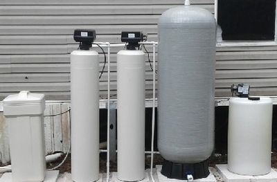 Well water treatment system retention tank chlorine pump  flow switch carbon filter and water soften