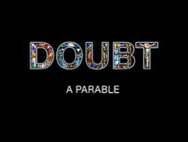 Doubt is written in all caps  in a font that looks like  stained glass windows on a completely black