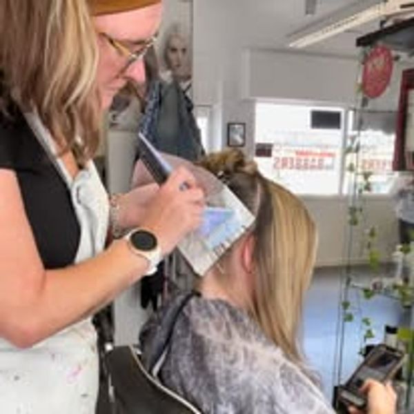 Roxanne in the salon highlighting a clients hair in inverness scotland. lived in blonde balayage ash