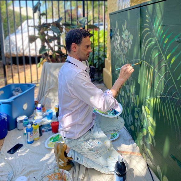 Palm Beach mural artist Delyan Kosto painting exterior mural art