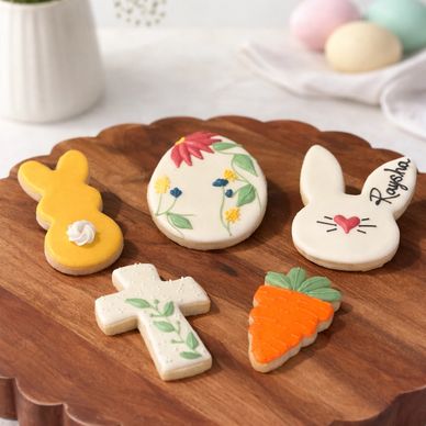 Decorative Easter-themed cookies on a wooden board.