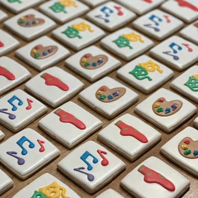 Tiles decorated with colorful music, art, and theater symbols.