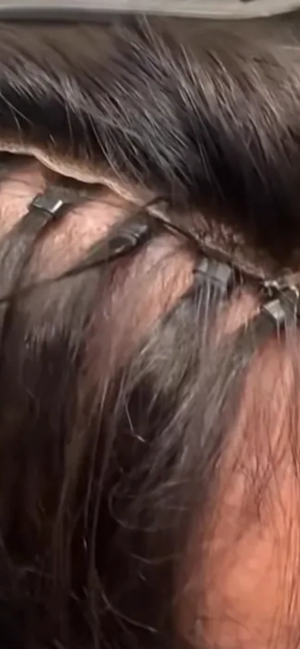 Close-up of hair extensions being clipped in.
