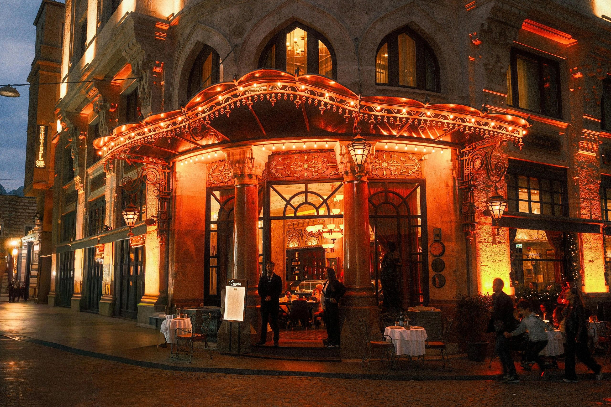 Premium hotel facade with guests entering and security staff ensuring safety at the entrance
