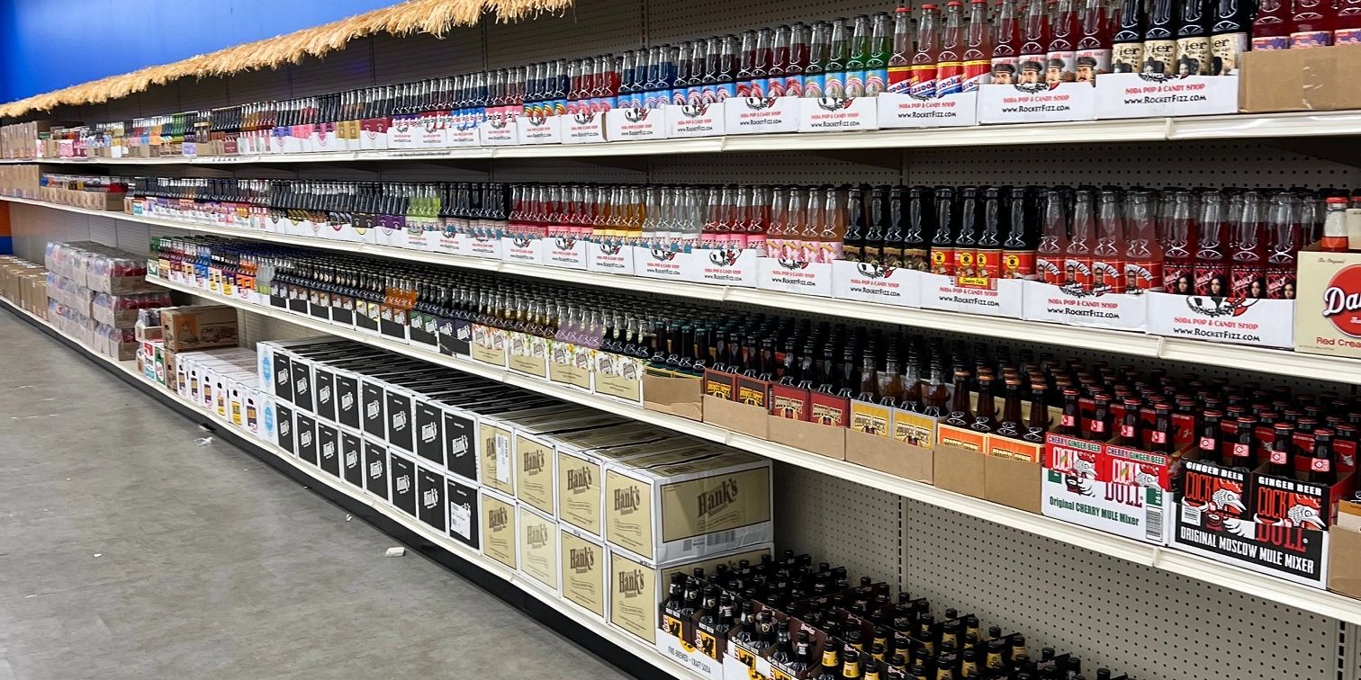 Wall of different types of sodas in glass bottles