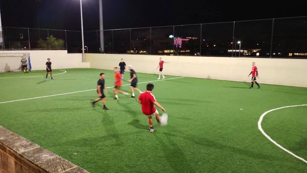Casual game of of 5 a-side football played at the loftus centre outdoor on a turf pitch at night