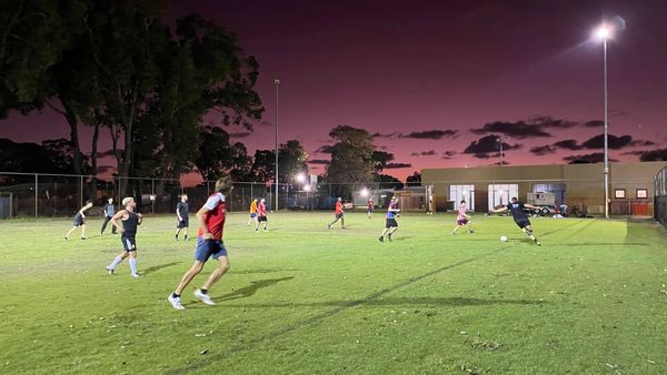 Social soccer played at sunset under floodlights in Yokine, Western Australia
