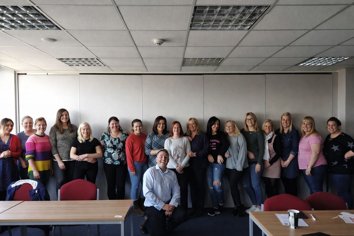 A group of people posing together in a conference room.
