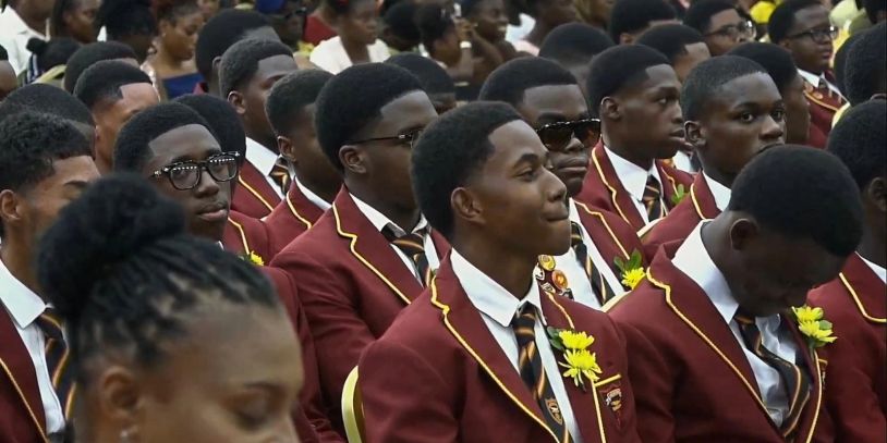 Students in maroon blazers at an event.